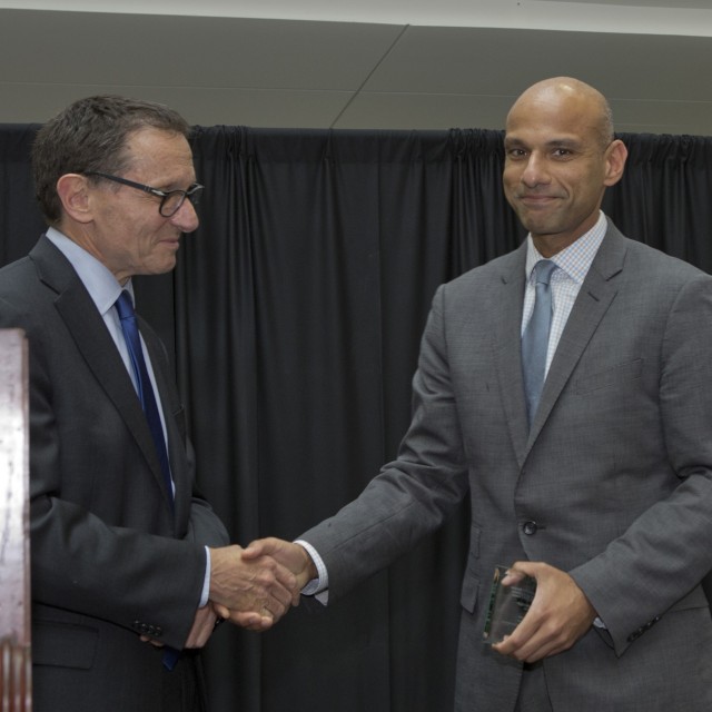 Dean Polonsky and Mustafa Hussain shaking hands